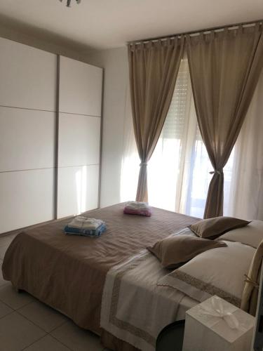 a bedroom with a large bed with a window at Le Miromí in Civitanova Marche