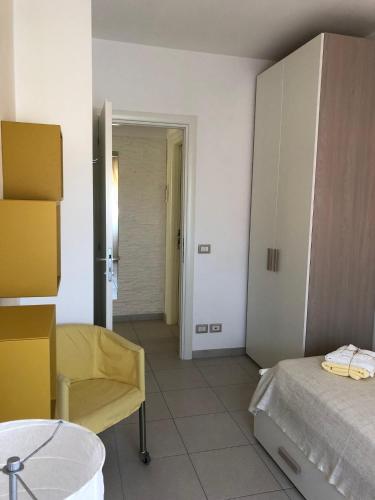a room with a bed and a chair in a room at Le Miromí in Civitanova Marche
