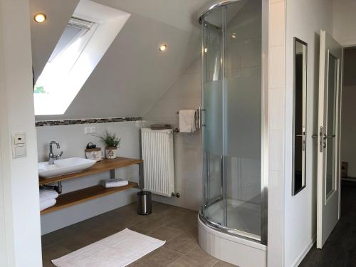 a bathroom with a shower and a sink at Landhaus N°3 in Perl