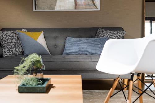 a living room with a couch with pillows on it at Little Santa in Ginowan