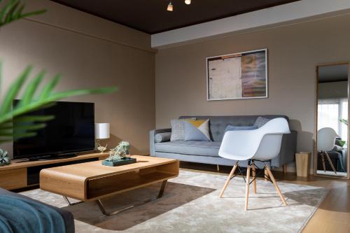 a living room with a couch and a tv at Little Santa in Ginowan