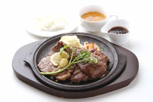 a plate of food with meat and vegetables on a table at Hotel Aqua Kiss Moriyama (Adult Only) in Moriyama