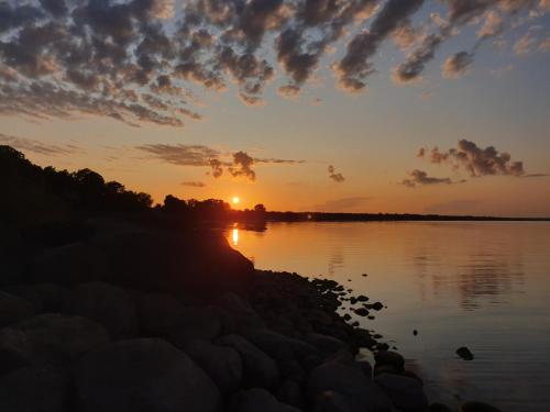 a sunset over a body of water at Nina puhkemaja in Nina