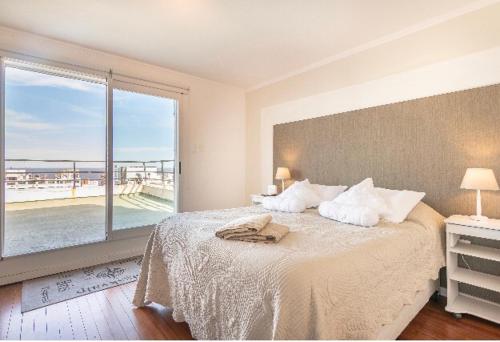 1 dormitorio con 1 cama y vistas al océano en Plaza Cagancha, en Montevideo