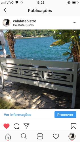 a picture of a bench in front of a lake at Cabana do Mar in Angra dos Reis