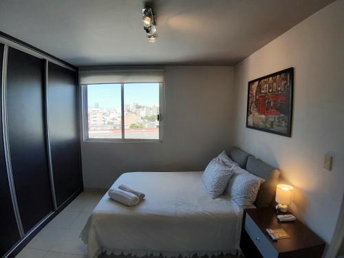 a small bedroom with a bed and a window at Becerra Apartments in Mexico City
