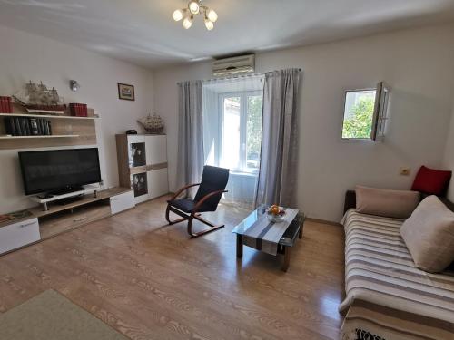 a living room with a couch and a table at Big and Spacious Apartment in the heart of Omi&scaron; in Omi&scaron;