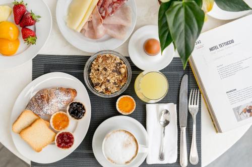 a table topped with plates of breakfast foods at Grand Hotel Tettuccio in Montecatini Terme