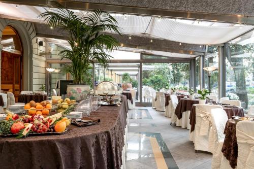 a long table with fruit on it in a restaurant at Grand Hotel Tettuccio in Montecatini Terme
