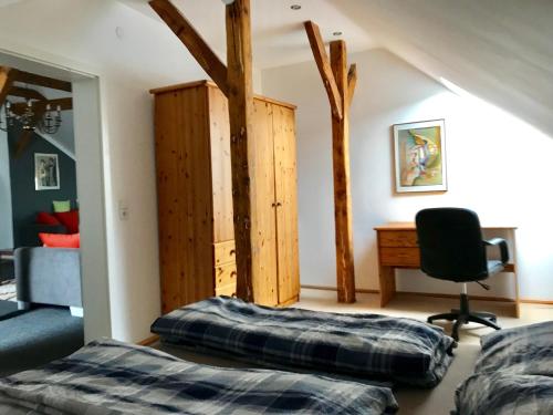 a bedroom with a bed and a desk in a room at Historic Apartments in Bremen-Vegesack