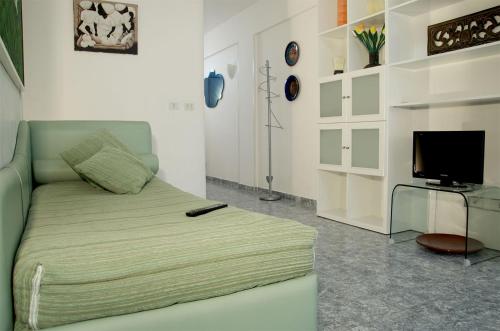 a bedroom with a bed with a remote control on it at Residence Castello Otranto in Otranto