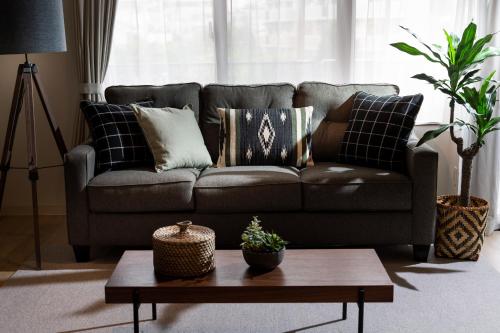 a living room with a couch and a coffee table at Little Santa in Ginowan