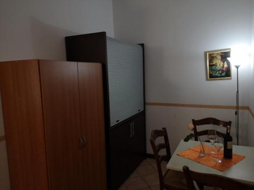a dining room with a table and a cabinet at Ca' Del Sasso in Verona