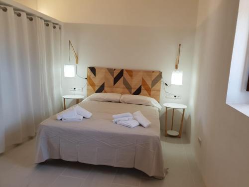 a bedroom with a bed with two towels on it at Can Vicent Yern in Sant Francesc Xavier