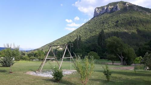 a field with a mountain in the background at Le petit nid douillet in Trescléoux