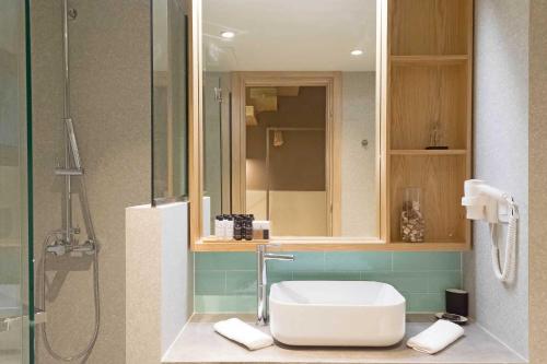a bathroom with a toilet and a shower and a sink at Eco Green Residences & Suites in Toroni