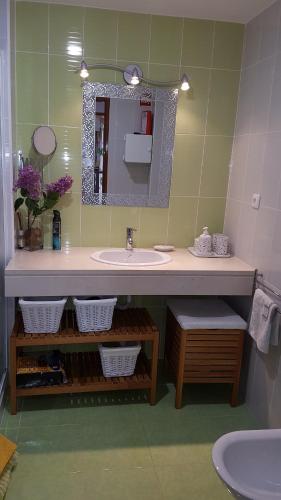 a bathroom with a sink and a mirror at Algarve/Sra da Rocha in Porches