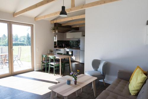 a living room with a couch and a table at Lytte Hytte - Ferienhaus Wingst in Wingst