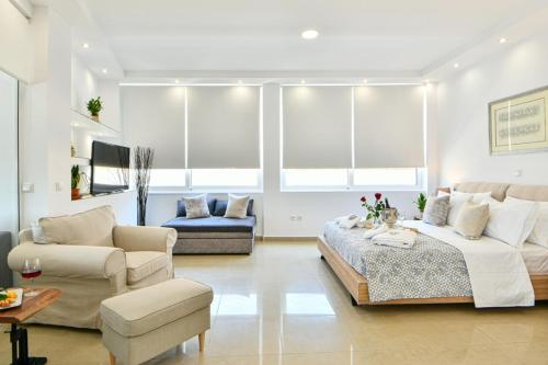 a living room with a bed and a couch at AEOLIS SUITES in Athens