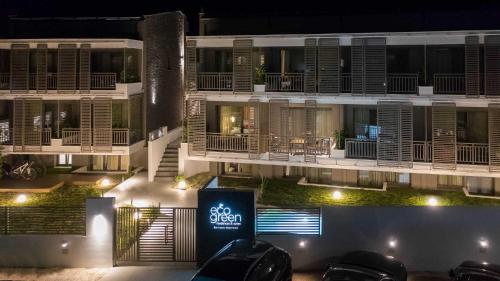 a building with a sign in front of it at night at Eco Green Residences & Suites in Toroni