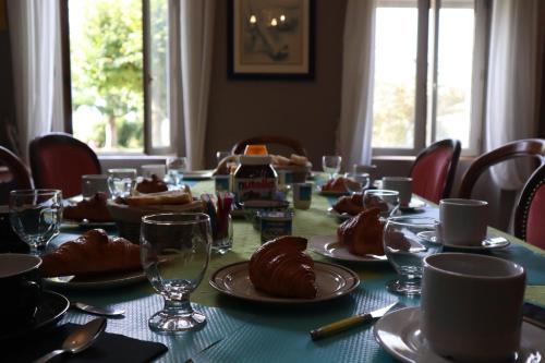 une table avec des assiettes de nourriture et des verres dessus dans l'établissement Domaine des Tilleuls, à Marcillac