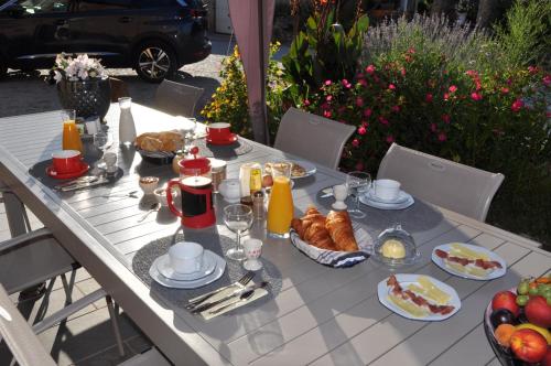 a white table with breakfast foods on it at Chambre d'hôtes Sauternais in Pujols-sur-Ciron
