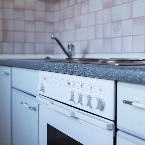 a white stove top oven in a kitchen at Landhotel Bodensee in Konstanz