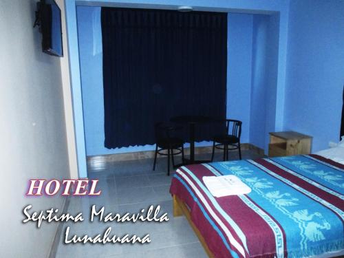 a hotel room with a bed and a table at Hotel Septima Maravilla Lunahuana in Lunahuaná