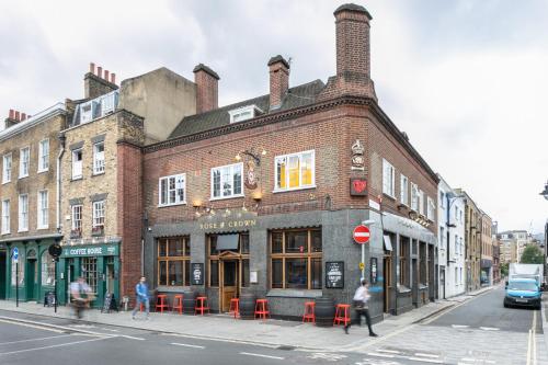 a brick building on the corner of a street at PubLove @ The Rose & Crown in London