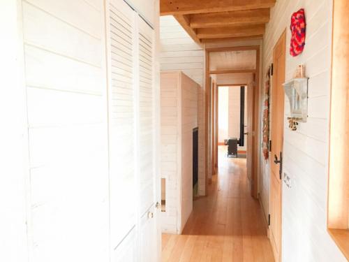 a hallway of a house with white walls and wood floors at Casa Cerro Castillo in Villa Cerro Castillo