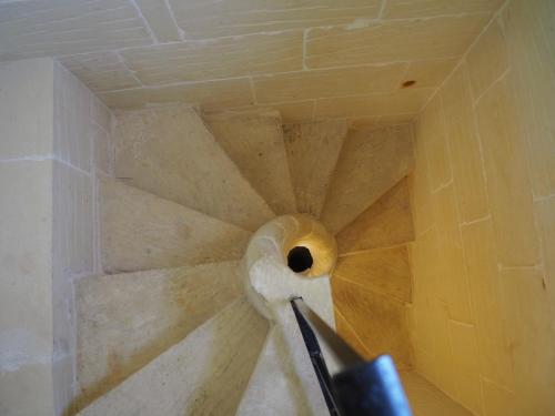 a spiral staircase with a hole in the ceiling at Gozo Rustic Farmhouse with stunning views and swimming pool in Sannat