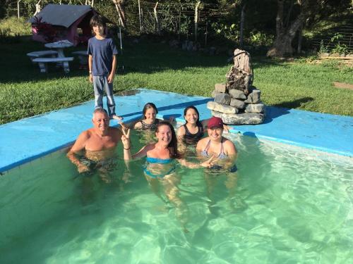 a group of people in the water in a pool at Ginebra Glamping in Ginebra