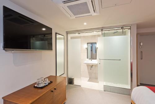 a bedroom with a bathroom with a sink and a mirror at Templebar Rooms in Dublin