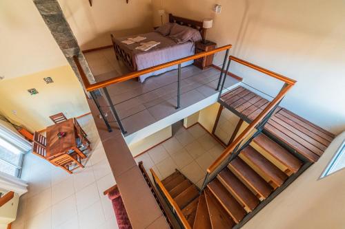 vistas a una habitación con cama y escaleras en Camiare Aparts en Villa General Belgrano