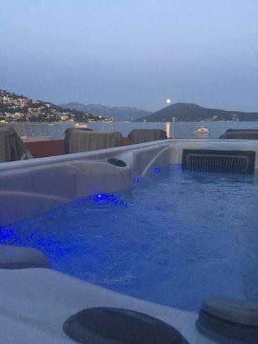 a hot tub with blue water on a roof at Apartments Adriatico in Herceg-Novi