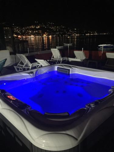 a large blue hot tub sitting on top of a boat at Apartments Adriatico in Herceg-Novi