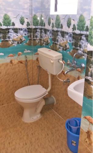 a bathroom with a toilet and a sink at Samantha Inn Beach Resort in Arambol