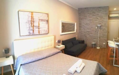 a bedroom with a bed and a couch at Bixio Suites in La Spezia