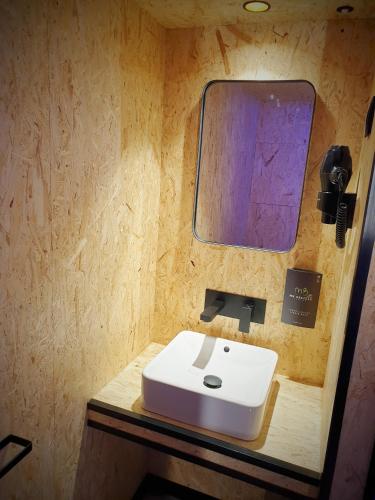 a bathroom with a white sink and a mirror at MB Hostels Premium ECO - Adults Recommended in Nerja