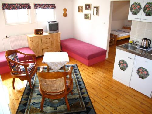 a kitchen and living room with a table and chairs at Villa Blanka in Horní Podkozí