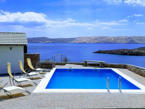 a swimming pool with a view of the water at Villa Mihaela - Apartment Ika in Cesarica
