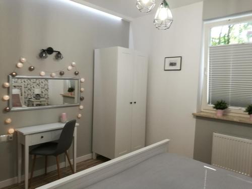 a small room with a desk and a mirror at Apartament Mini in Lublin