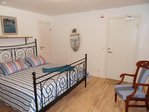 a bedroom with a bed and a chair at Mellby Ör Inn in Mellby
