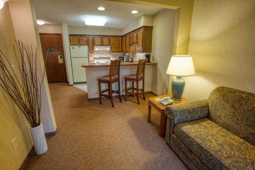 a living room with a couch and a kitchen at Sophie Station Suites in Fairbanks