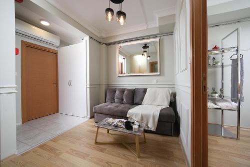 a living room with a couch and a table at Beddington Residence Sisli in Istanbul