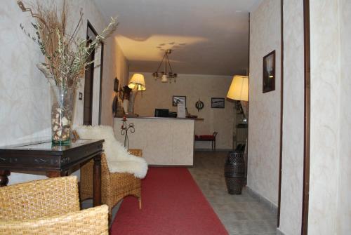 a living room with a table and a kitchen at Chalet Edelweiss - Estella Hotel Collection in Sestriere