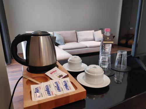 a coffee maker on a table in a living room at Supreme Hotel in Golem