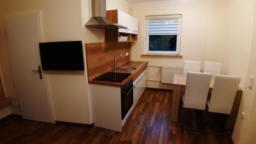 a small kitchen with a sink and a counter at Ferienwohnung Smillenzweg mit Garten in Lohme