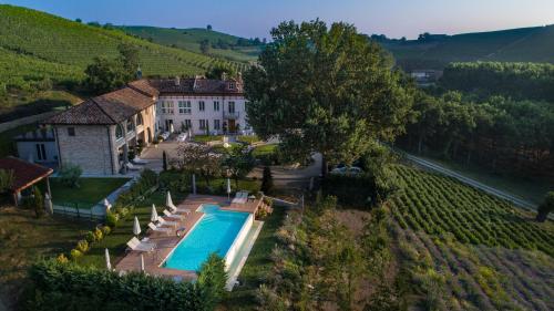 an aerial view of a house with a swimming pool at Langhe Country House in Neive