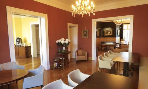 a dining room with tables and white chairs at Hotel Hollerbusch in Weimar